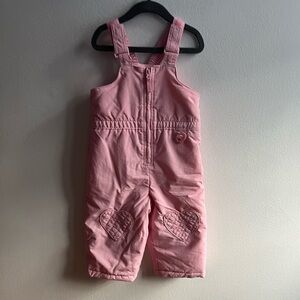 Baby pink snow bib with heart patch on knees 24m
